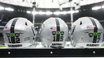 Nov 23, 2025; Paradise, Nevada, USA; The Las Vegas Raiders helmets of Las Vegas Raiders quarterback Aidan O'Connell (12), quarterback Kenny Pickett (15) and quarterback Geno Smith (7) with the Salute to Service decals and emblems honoring Al Davis and Carol Davis at Allegiant Stadium. Mandatory Credit: Kirby Lee-Imagn Images