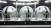 Nov 23, 2025; Paradise, Nevada, USA; The Las Vegas Raiders helmets of Las Vegas Raiders quarterback Aidan O'Connell (12), quarterback Kenny Pickett (15) and quarterback Geno Smith (7) with the Salute to Service decals and emblems honoring Al Davis and Carol Davis at Allegiant Stadium. Mandatory Credit: Kirby Lee-Imagn Images