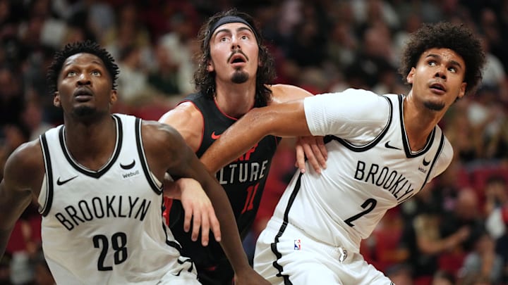 Nov 16, 2023; Miami, Florida, USA;  Miami Heat guard Jaime Jaquez Jr. (11) battles for position with Brooklyn Nets forward Dorian Finney-Smith (28) and forward Cameron Johnson (2) in the first half at Kaseya Center. Mandatory Credit: Jim Rassol-Imagn Images