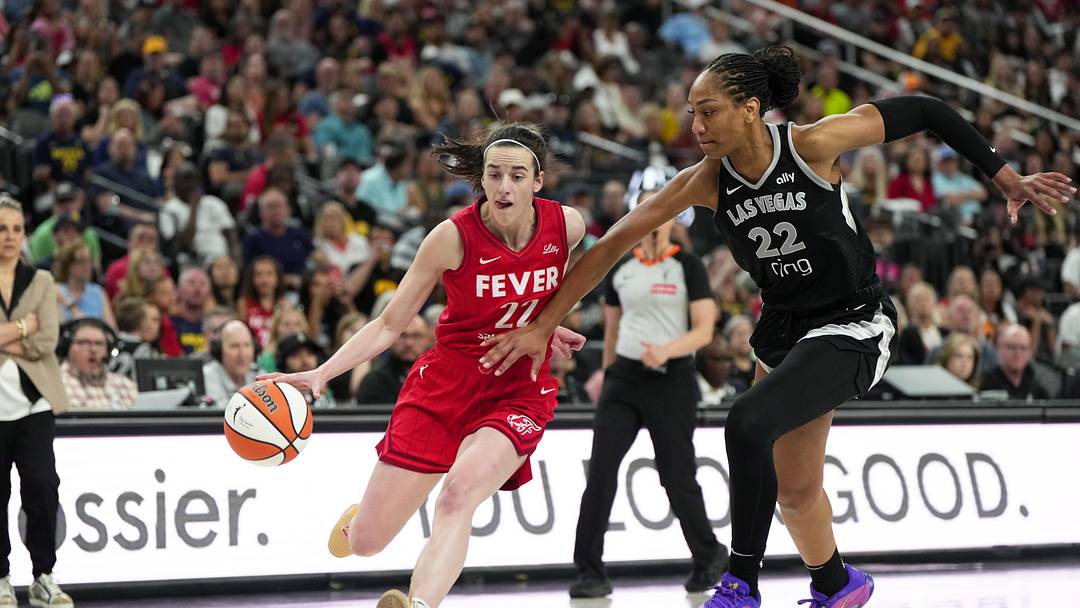 Jun 22, 2025; Las Vegas, Nevada, USA; Indiana Fever guard Caitlin Clark (22) dribbles the ball against Las Vegas Aces center A'ja Wilson (22) during the second half of a WNBA basketball game at T-Mobile Arena. Mandatory Credit: Lucas Peltier-Imagn Images