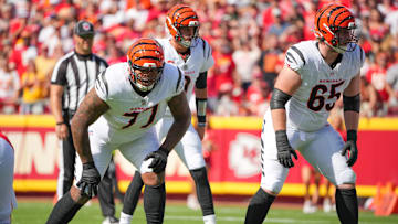 Sep 15, 2024; Kansas City, Missouri, USA; Cincinnati Bengals offensive tackle Trent Brown (77) and guard Alex Cappa (65) on the line of scrimmage against the Kansas City Chiefs during the game at GEHA Field at Arrowhead Stadium. Mandatory Credit: Denny Medley-Imagn Images