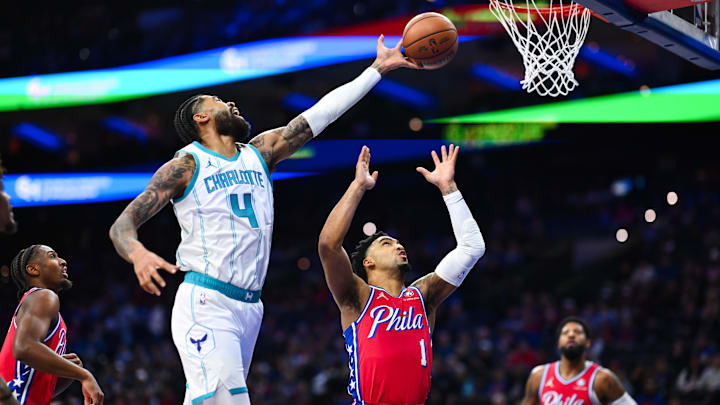 Dec 20, 2024; Philadelphia, Pennsylvania, USA; Charlotte Hornets center Nick Richards (4) reaches for the ball against Philadelphia 76ers forward KJ Martin (1) in the first quarter at Wells Fargo Center. Mandatory Credit: Kyle Ross-Imagn Images