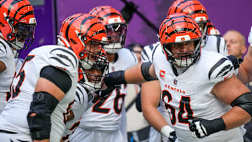 Cincinnati Bengals center Ted Karras (64) leads onto the field during warmups before the first quarter of the NFL Week 3 game between the Minnesota Vikings and the Cincinnati Bengals at U.S. Bank Stadium in Minneapolis on Sunday, Sept. 21, 2025.