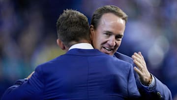 Oct 20, 2024; Indianapolis, Indiana, USA; Peyton Manning hugs Dallas Clark as Clark is inducted in the Ring of Honor on during a game against the Miami Dolphins at Lucas Oil Stadium . Mandatory Credit: Grace Hollars/IndyStar USA TODAY Network via Imagn Images
