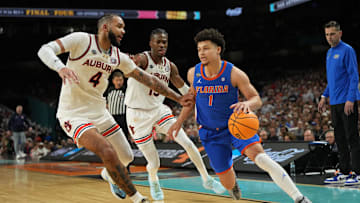 Apr 5, 2025; San Antonio, TX, USA; Florida Gators guard Walter Clayton Jr. (1) dribbles the ball against Auburn Tigers forward Johni Broome (4) during the second half in the semifinals of the men's Final Four of the 2025 NCAA Tournament at the Alamodome. Mandatory Credit: Bob Donnan-Imagn Images