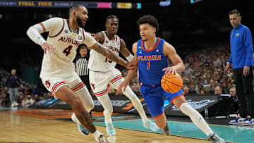 Florida Gators guard Walter Clayton Jr. (1) dribbles the ball against Auburn Tigers forward Johni Broome (4)