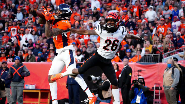 Dec 19, 2021; Denver, Colorado, USA; Denver Broncos wide receiver Tim Patrick (81) catches a pass for a touchdown past Cincinnati Bengals cornerback Trae Waynes (26) in the third quarter at Empower Field at Mile High Mandatory Credit: Ron Chenoy-USA TODAY Sports