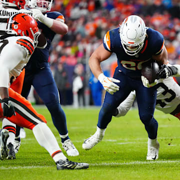 Dec 2, 2024; Denver, Colorado, USA; Denver Broncos fullback Michael Burton (20) scores a touchdown past Cleveland Browns linebacker Mohamoud Diabate (43) in the second quarter at Empower Field at Mile High. Mandatory Credit: Ron Chenoy-Imagn Images