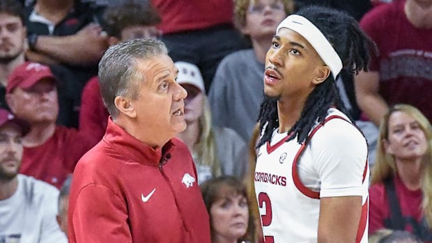 Razorbacks coach John Calipari and point guard Boogie Fland talking on the sidelines during exhibition game with Kansas