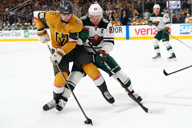 Hockey players battle for loose puck