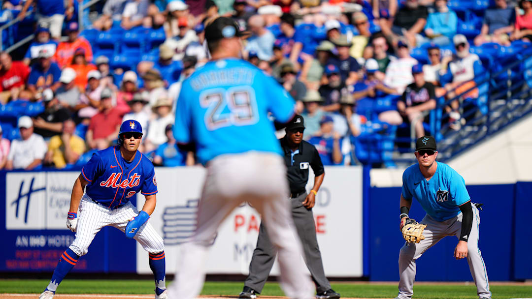 Mar 26, 2023; Port St. Lucie, Florida, USA; New York Mets center fielder Brandon Nimmo (9) and Miami Marlins first baseman Troy Johnston (46) watch Miami Marlins starting pitcher Braxton Garrett (29) throw a pitch during the third inning at Clover Park. 