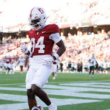 Sep 7, 2024; Stanford, California, USA; Stanford Cardinal wide receiver Ismael Cisse (84) scores a touchdown against the Cal Poly Mustangs during the second half at Stanford Stadium. Mandatory Credit: Sergio Estrada-Imagn Images