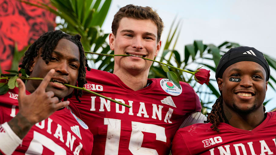 Indiana Hoosiers quarterback Fernando Mendoza celebrates winning the Rose Bowl with teammates.