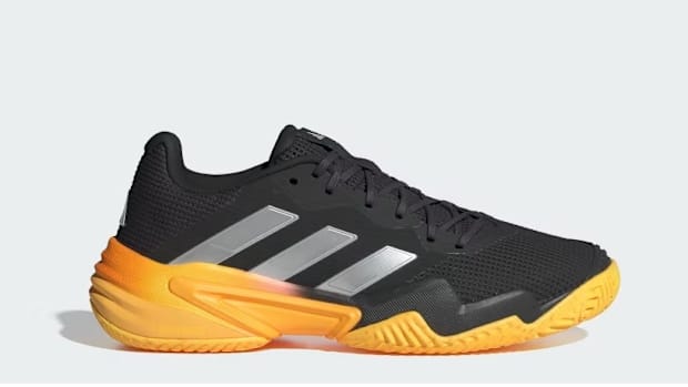Black and yellow adidas tennis shoes.