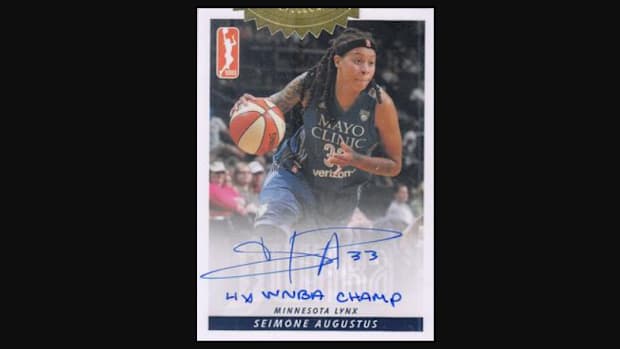 Seimone Augustus mid-dribble with her autograph under the photo and "4x WNBA Champ" inscribed