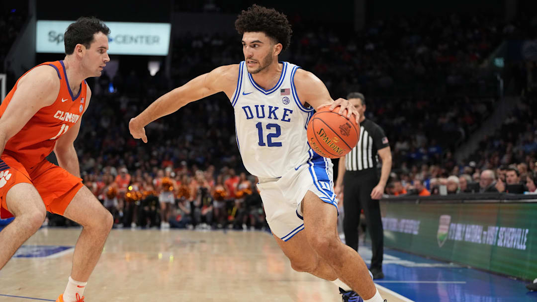 Duke Blue Devils forward Cameron Boozer (12) with the ball as Clemson Tigers forward Nick Davidson (11) defends in the second half at Spectrum Center. 