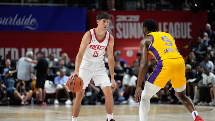 Jul 12, 2024; Las Vegas, NV, USA; Houston Rockets guard Reed Sheppard (15) dribbles the ball against Los Angeles Lakers guard Bronny James (9) during the first half at Thomas & Mack Center. Mandatory Credit: Lucas Peltier-USA TODAY Sports