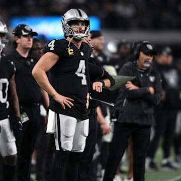 Jan 9, 2022; Paradise, Nevada, USA; Las Vegas Raiders quarterback Derek Carr (4) looks on from the sideline during the second half against the Los Angeles Chargers at Allegiant Stadium. Mandatory Credit: Orlando Ramirez-Imagn Images