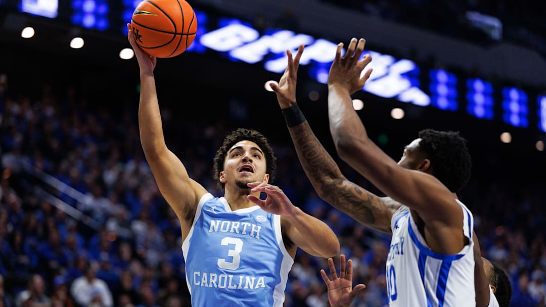 Dec 2, 2025; Lexington, Kentucky, USA; North Carolina Tar Heels guard Derek Dixon (3) goes to the basket against Kentucky Wildcats guard Otega Oweh (00) during the first half at Rupp Arena at Central Bank Center. Mandatory Credit: Jordan Prather-Imagn Images