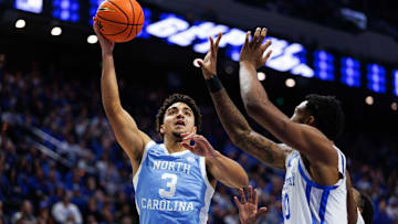 Dec 2, 2025; Lexington, Kentucky, USA; North Carolina Tar Heels guard Derek Dixon (3) goes to the basket against Kentucky Wildcats guard Otega Oweh (00) during the first half at Rupp Arena at Central Bank Center. Mandatory Credit: Jordan Prather-Imagn Images