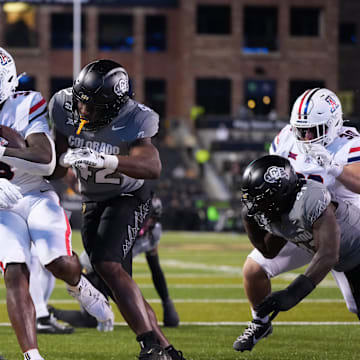 Nov 1, 2025; Boulder, Colorado, USA; Arizona Wildcats running back Kedrick Reescano (3) scores a touchdown past Colorado Buffaloes linebacker Jeremiah Brown (42) in the second half at Folsom Field. Mandatory Credit: Ron Chenoy-Imagn Images
