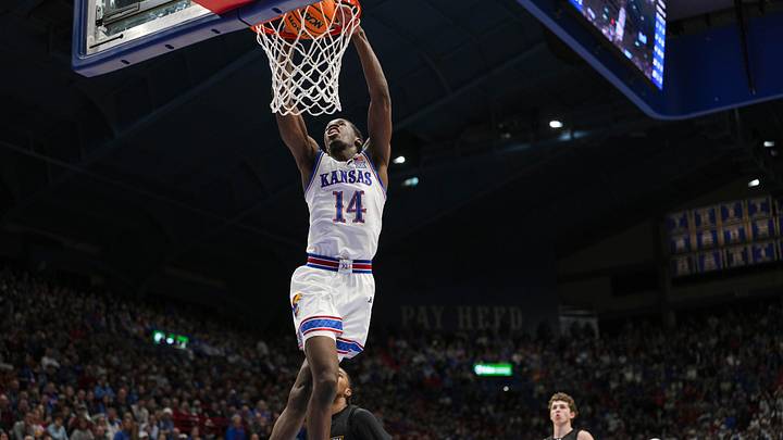 Dec 16, 2025; Lawrence, Kansas, USA; Kansas Jayhawks guard Melvin Council Jr. (14) dunks the ball during the first half against the Towson Tigers at Allen Fieldhouse. Mandatory Credit: Jay Biggerstaff-Imagn Images