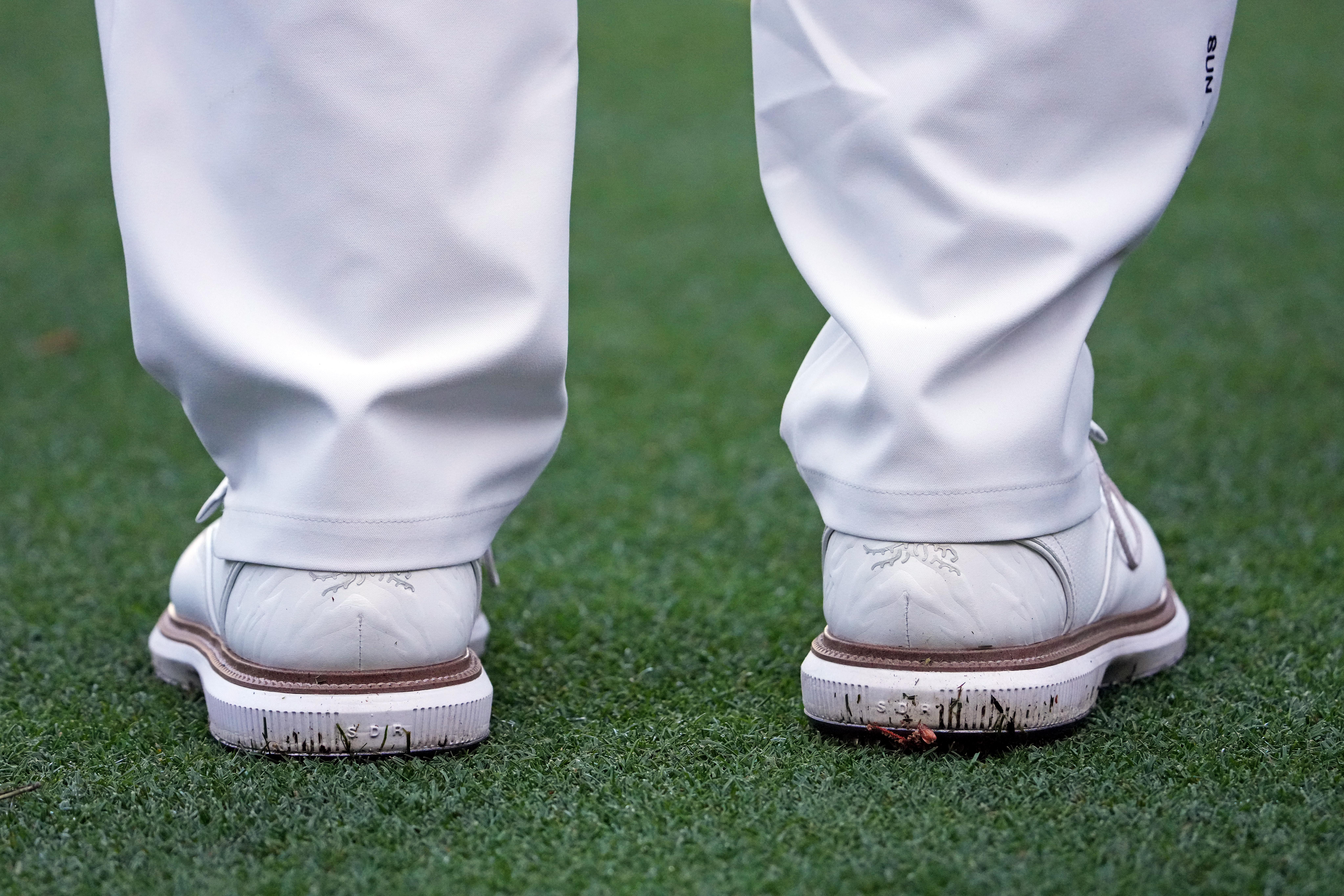 The heels of Tiger Woods' white golf shoes.