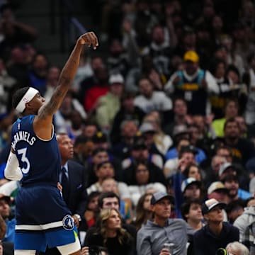 Mar 12, 2025; Denver, Colorado, USA; Minnesota Timberwolves forward Jaden McDaniels (3) reacts after a three point basket in the second half against the Denver Nuggets at Ball Arena. Mandatory Credit: Ron Chenoy-Imagn Images
