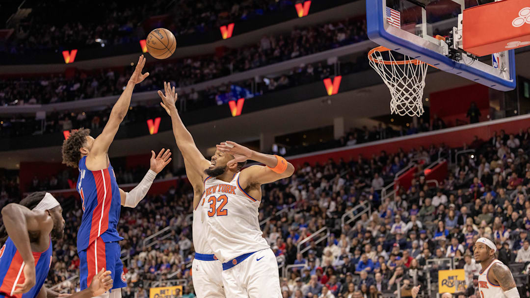 Apr 10, 2025; Detroit, Michigan, USA; Detroit Pistons guard Cade Cunningham (2) shoots the ball over New York Knicks center Karl-Anthony Towns (32) during the second half at Little Caesars Arena. Mandatory Credit: David Reginek-Imagn Images