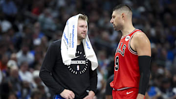 Nov 6, 2024; Dallas, Texas, USA; Dallas Mavericks guard Luka Doncic (77) laughs with Chicago Bulls center Nikola Vucevic (9) during the second half at American Airlines Center. Mandatory Credit: Kevin Jairaj-Imagn Images