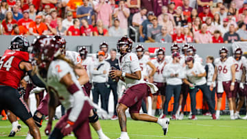 Sep 27, 2025; Raleigh, North Carolina, USA;  Virginia Tech Hokies quarterback Kyron Drones (1) with the ball during the first half of the game against North Carolina State Wolfpack at Carter-Finley Stadium. Mandatory Credit: Jaylynn Nash-Imagn Images