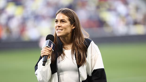 Kelley O’Hara gives a thank you speech after being awarded a jersey for her retirement after 160 games with the United States