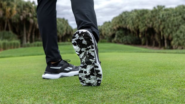 Black and white Reebok golf shoes.