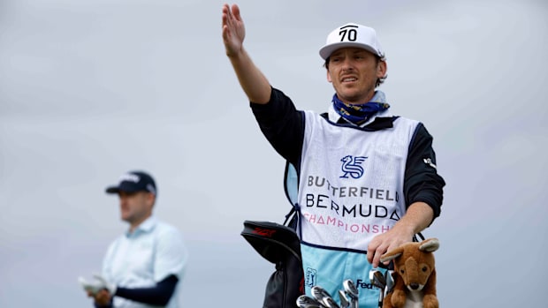 Russell Knox looks on his caddie, former PGA Tour pro Willy Wilcox advises him at the 2021 Butterfield Bermuda Championship.