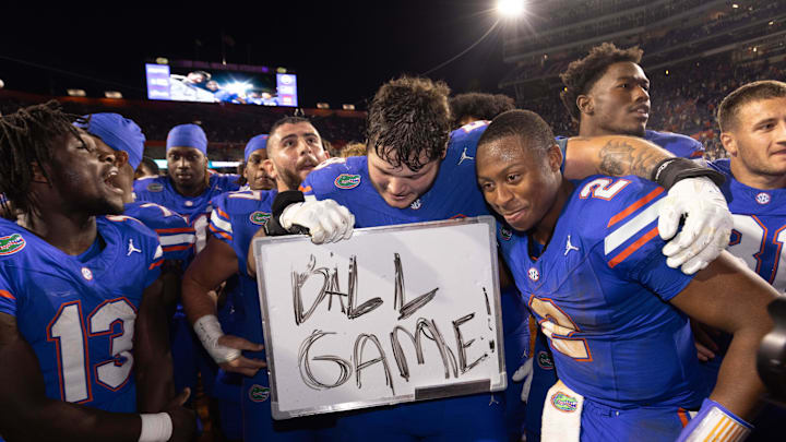Florida Gators offensive lineman Austin Barber (58) pulls in Florida Gators quarterback DJ Lagway (2) as the Gators celebrated at Ben Hill Griffin Stadium in Gainesville, FL on Saturday, November 16, 2024. The Gators defeated the Tigers 27-16. [Doug Engle/Gainesville Sun]