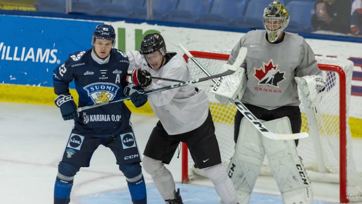 Aug 2, 2024; Plymouth, MI, USA; Canada goaltender Joshua Ravensbergen (1) follows the play as defenseman Quinton Burns (3) defends against Finland forward Rasmus Kumpulainen (22) during the second period of the 2024 World Junior Summer Showcase at USA Hockey Arena. Mandatory Credit: David Reginek-USA TODAY Sports