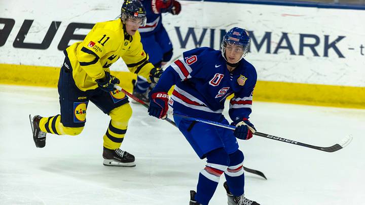Aug 2, 2024; Plymouth, MI, USA; USA’s forward Chris Pelosi (20) follows the play in front of Sweden's forward Lucas Pettersson (11) during the second period of the 2024 World Junior Summer Showcase at USA Hockey Arena. Credit: David Reginek