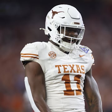 Jan 10, 2025; Arlington, Texas, USA; Texas Longhorns linebacker Colin Simmons (11) celebrates after a pass break up during the third quarter of the College Football Playoff semifinal against the Ohio State Buckeyes in the Cotton Bowl at AT&T Stadium. Mandatory Credit: Tim Heitman-Imagn Images