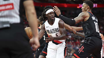Nov 14, 2025; Houston, Texas, USA;  Portland Trail Blazers guard Jrue Holiday (5) looks to pass the ball as Houston Rockets forward Jabari Smith Jr. (10) defends during the third quarter at Toyota Center. Mandatory Credit: Troy Taormina-Imagn Images