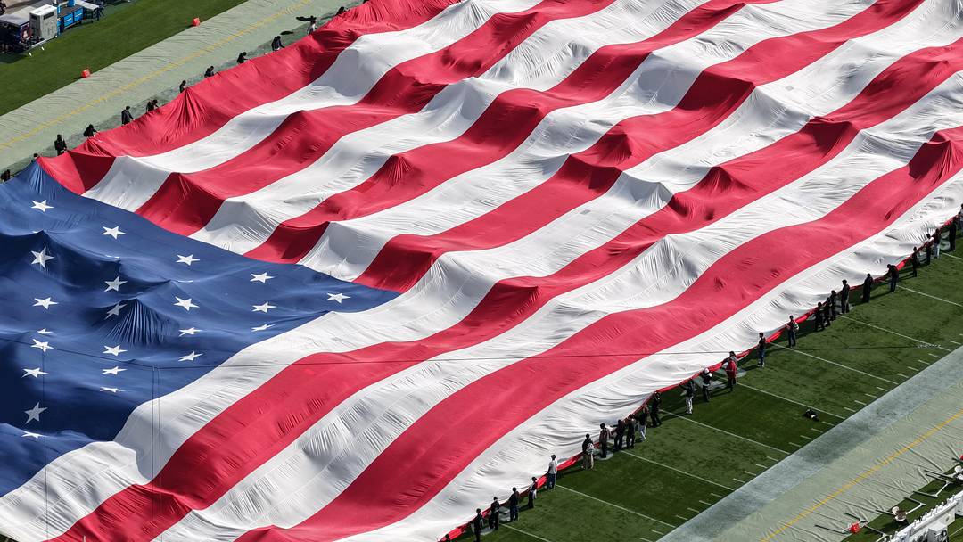 A general overall aerial view of a United States flag on the field for the SMU Mustangs. Mandatory Credit: Kirby Lee-Imagn Images