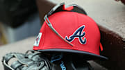 wMar 1, 2025; North Port, Florida, USA; A detail view of Atlanta Braves hat, sunglasses and glove in the dugout during the fifth inning at CoolToday Park. Mandatory Credit: Kim Klement Neitzel-Imagn Images