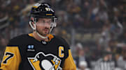 Mar 30, 2025; Pittsburgh, Pennsylvania, USA;  Pittsburgh Penguins center Sidney Crosby (87) looks on at the face-off circle against the Ottawa Senators during the first period at PPG Paints Arena. Mandatory Credit: Charles LeClaire-Imagn Images