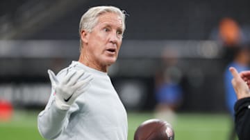 Sep 15, 2025; Paradise, Nevada, USA;  Las Vegas Raiders head coach Pete Carroll throws a football before the game against the Los Angeles Chargers at Allegiant Stadium. Mandatory Credit: Kiyoshi Mio-Imagn Images