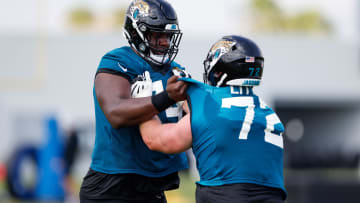 Jul 30, 2021; Jacksonville, FL, USA;  Jacksonville Jaguars offensive tackle Walker Little (72) and offensive tackle Cam Robinson (74) participate in training camp at Dream Finders Homes practice field.