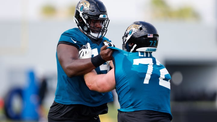 Jul 30, 2021; Jacksonville, FL, USA;  Jacksonville Jaguars offensive tackle Walker Little (72) and offensive tackle Cam Robinson (74) participate in training camp at Dream Finders Homes practice field.