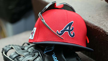 wMar 1, 2025; North Port, Florida, USA; A detail view of Atlanta Braves hat, sunglasses and glove in the dugout during the fifth inning at CoolToday Park. Mandatory Credit: Kim Klement Neitzel-Imagn Images