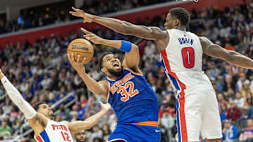 Apr 27, 2025; Detroit, Michigan, USA; New York Knicks center Karl-Anthony Towns (32) drives to the basket between Detroit Pistons center Jalen Duren (0) and forward Tobias Harris (12) : David Reginek-Imagn Images
