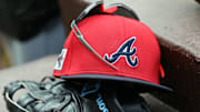 Mar 1, 2025; North Port, Florida, USA; A detail view of Atlanta Braves hat, sunglasses and glove in the dugout during the fifth inning at CoolToday Park. Mandatory Credit: Kim Klement Neitzel-Imagn Images