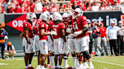 Sep 6, 2025; Raleigh, North Carolina, USA; North Carolina State Wolfpack huddle during the first half of the game against Virginia Cavaliers at Carter-Finley Stadium. Mandatory Credit: Jaylynn Nash-Imagn Images