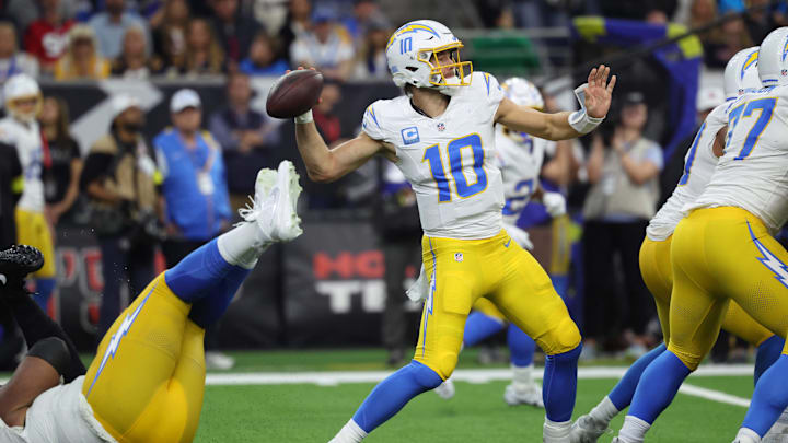 Jan 11, 2025; Houston, Texas, USA; Los Angeles Chargers quarterback Justin Herbert (10) looks to pass during the second quarter against the Houston Texans in an AFC wild card game at NRG Stadium. Mandatory Credit: Troy Taormina-Imagn Images
